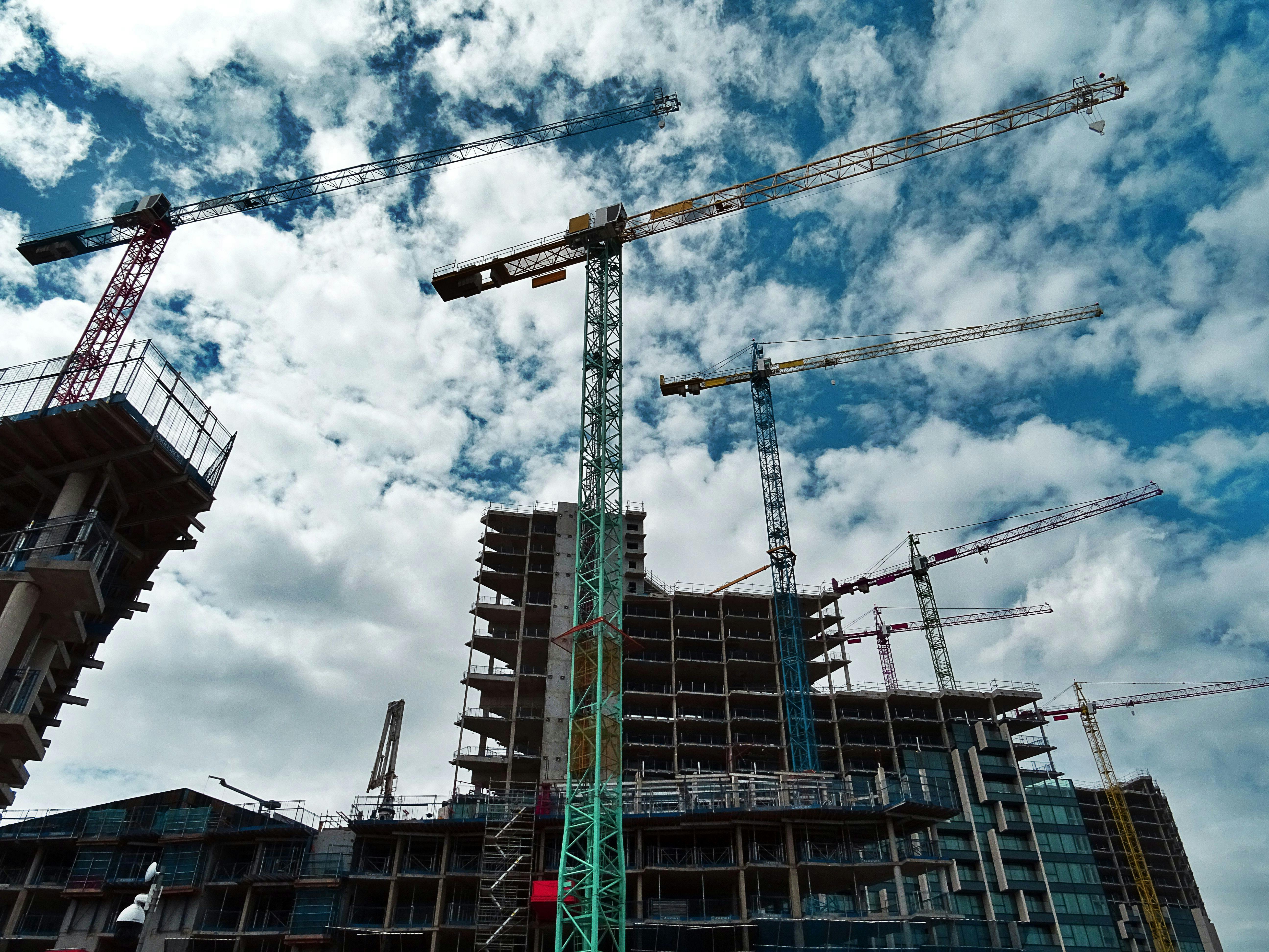 Construction cranes at high-rise building site